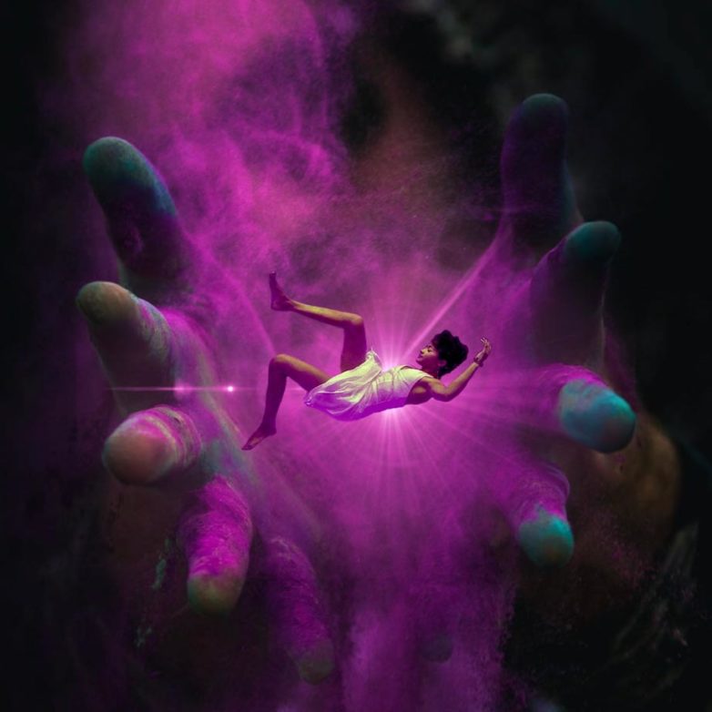 An artistic design of a woman falling in a purple haze into hands made with Bazaart photo editor